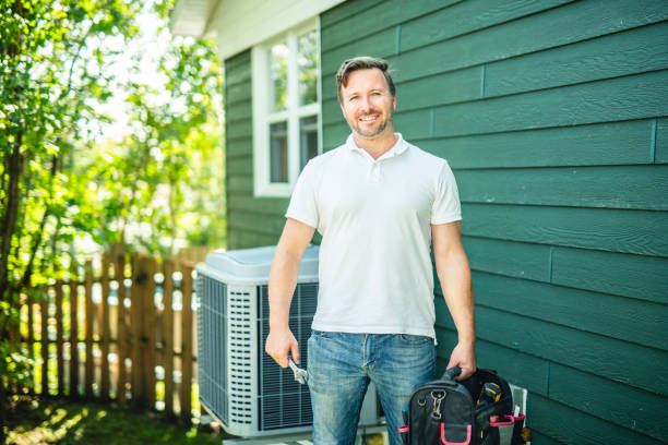 a technician working on air conditioning or heat pump outdoor unit a technician working on air conditioning or heat pump outdoor unit